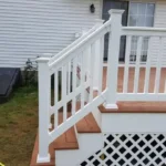 Image of a white railings on a deck and stairs.