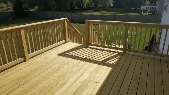 Photo of a deck that is 12'x24' second story deck with fully framed screened room clad in T-111