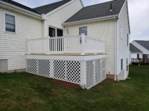 Wood deck with PVC railings and framed lattice with door