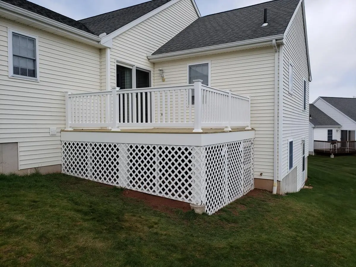 Wood deck with PVC railings and framed lattice with door