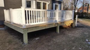 Wood deck with vinyl fully-reinforced railings