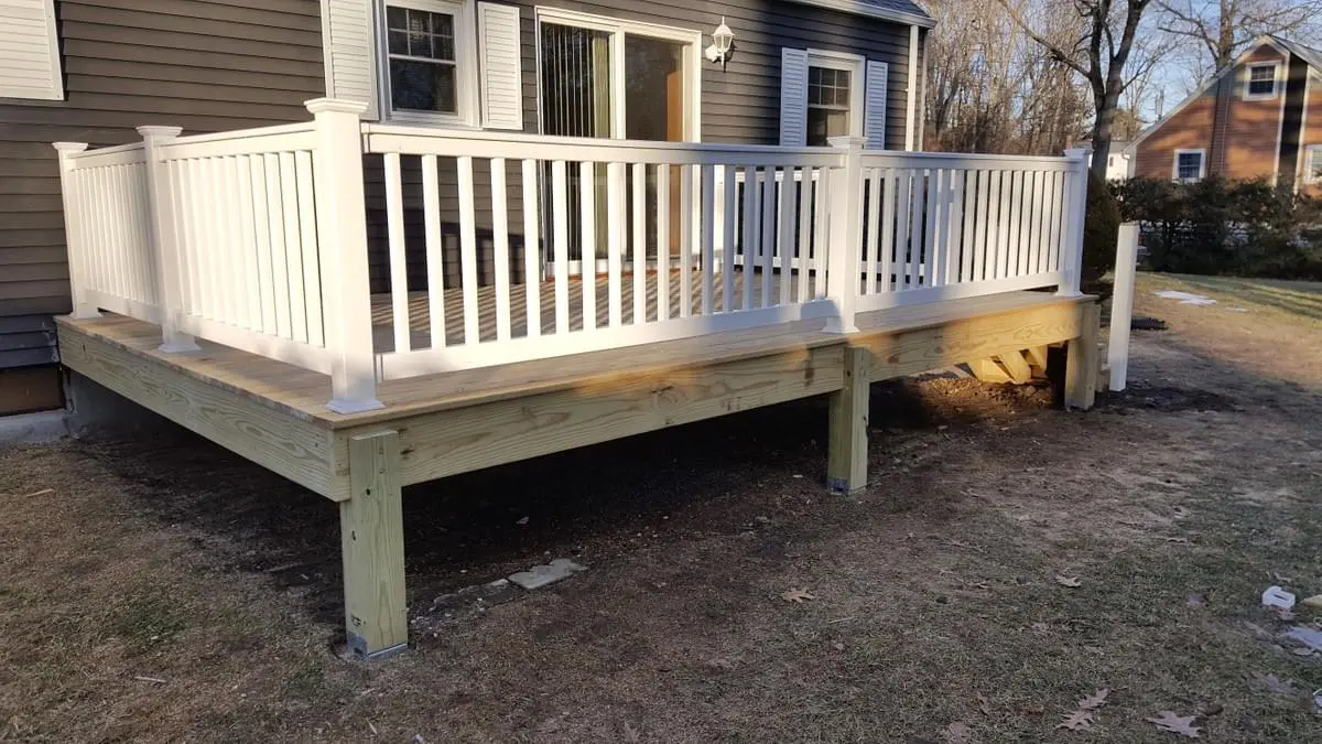 Wood deck with vinyl fully-reinforced railings